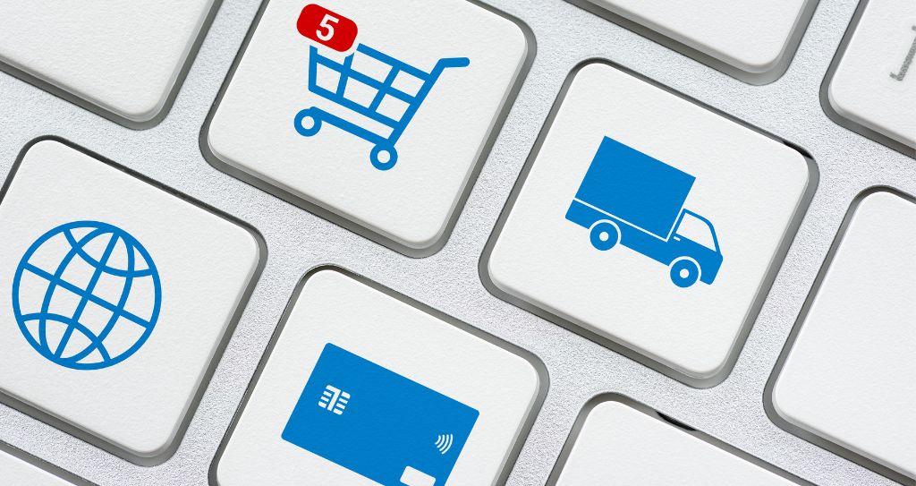 Teclas de teclado com ícones de carrinho de compras, entrega, pagamento e internet representando as etapas do e-commerce integradas por um gateway de pagamento.