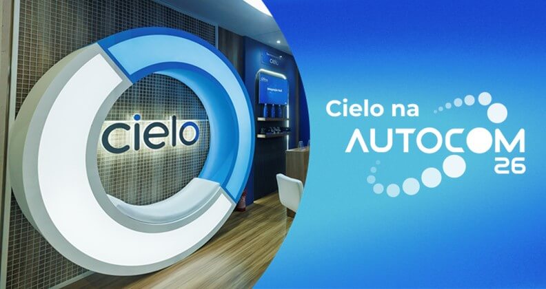 Estande da Cielo na feira AUTOCOM 2026, em São Paulo, com logotipo da marca em destaque e ambientação corporativa em tons de azul