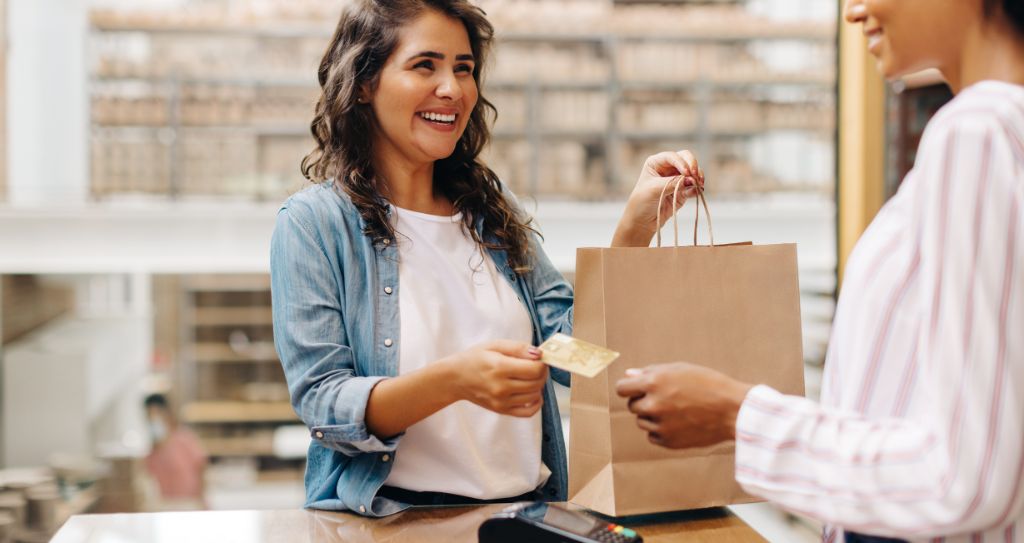 Cliente finaliza compra com cartão em loja física de cerâmicas, aproveitando as ofertas da Black Friday.